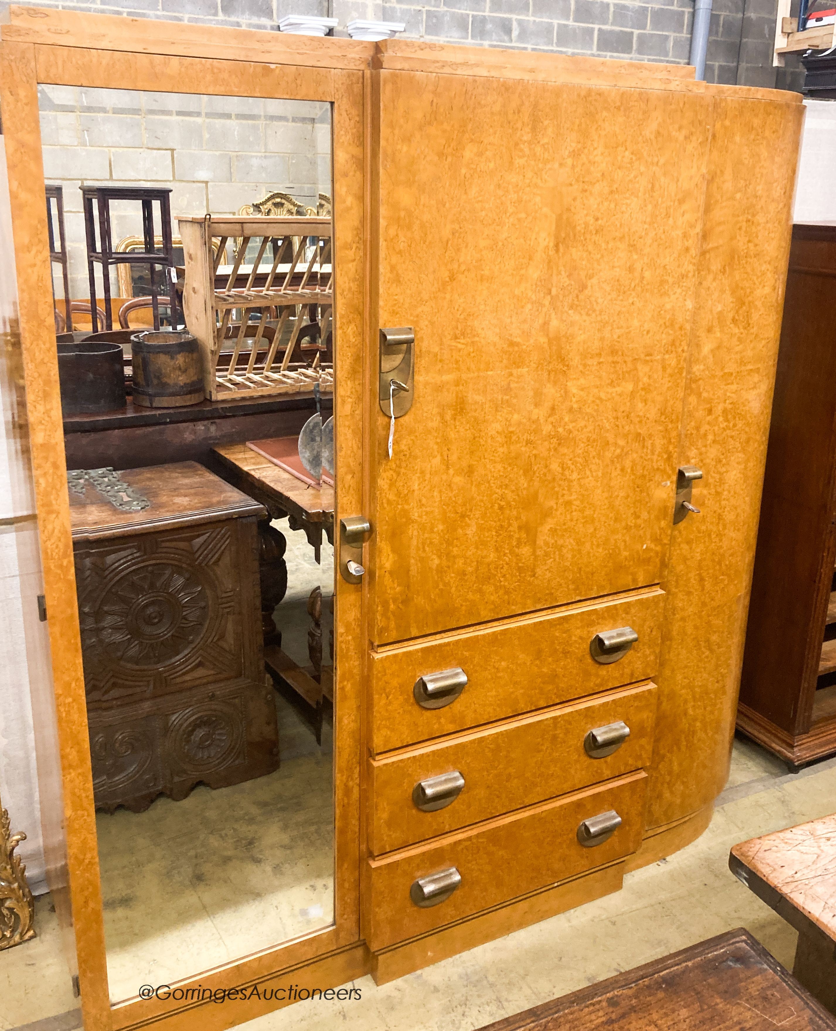 A French Art Deco birds eye maple and mahogany compactum wardrobe, W.174cm D.51cm H.181cm